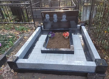 Широкий семейный памятник на участке с гранитным цоколем